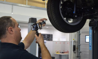 Technician recording a CitNOW workshop video, showing the tyre tread depth